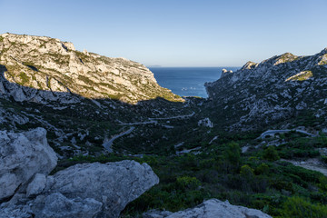 Fototapeta na wymiar beautiful rocky mountains with green vegetation and tranquil sea view in Calanques de Marseille (Massif des Calanques), provence, france