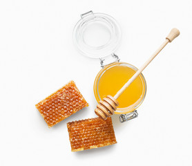 Jar full of fresh honey and honeycombs isolated on white