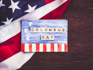 Blank notepad page with a pattern, wooden letters of the alphabet in the form of words Columbus day...