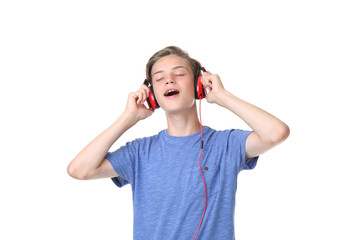 Cute teenager with headphones on white background