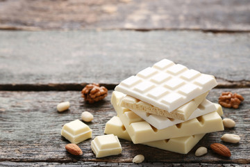 White chocolate bars with nuts on grey wooden table