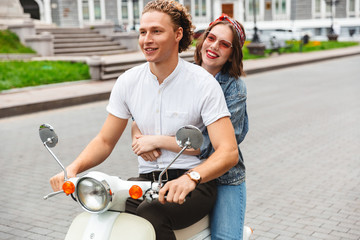 Portrait of a cheerful young couple riding