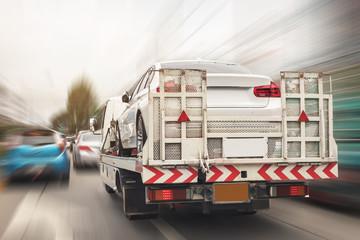 Broken car on tow truck after traffic accident, on the road service