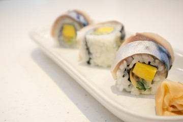 Saba sushi roll on white plate