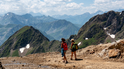 Fototapeta premium two women hikers on the trail of Pic du Midi de Bigorre in the Pyrenees