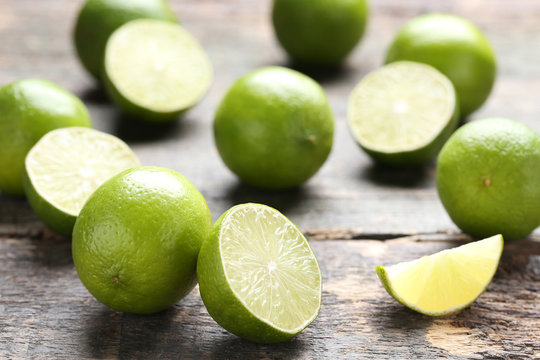 Ripe limes on grey wooden table