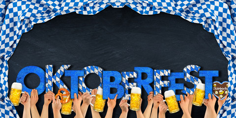 Oktoberfest people holding up blue white wooden letter lettering pretzel gingerbread heart and beer...