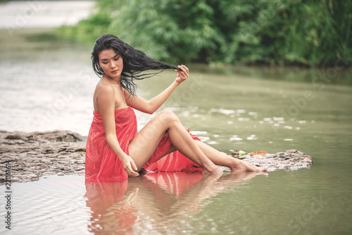 Beautiful Women In Red Cloth Happy Sitting Playing A Water