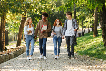 Group of happy student walking at the campus outdoors
