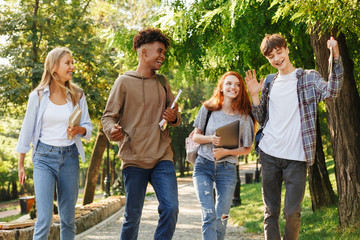 Group of cheerful students walking at the campus