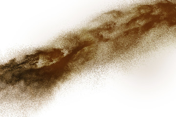 Deep Brown particles splattered on white background. Brown dust splash.