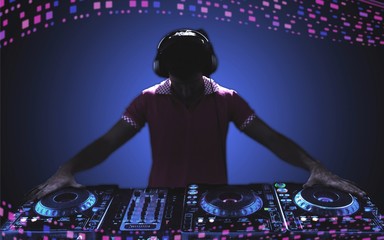 Portrait of confident young DJ with headphones on head mixing