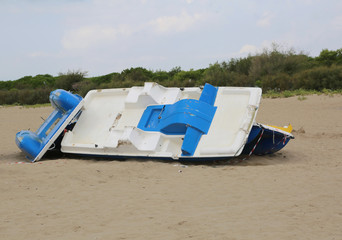 paddleboat destroyed on the beach