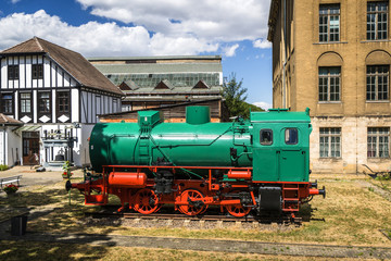 Fototapeta na wymiar Green and red locomotive on tracks