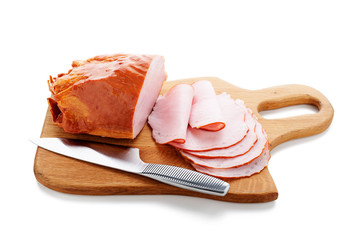 Delicious smoked sliced ham on a wooden board isolated on white.