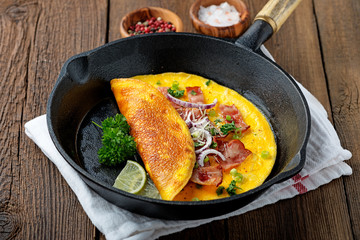 Fresh homemade omelette with bacon and onion.
