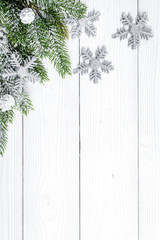 Christmas toys and spruce branches on wooden background top view