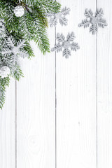 Christmas toys and spruce branches on wooden background top view