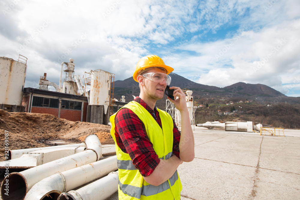 Wall mural Industrial worker talking on the phone