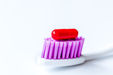 concept toothache with toothbrush and tablet at white background