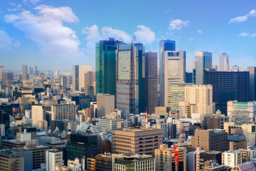 cityscape of tokyo city skyline in Aerial view with skyscraper, modern business office building with blue sky background in Tokyo metropolis city, Japan.