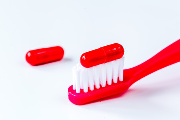 concept toothache with toothbrush and tablet at white background