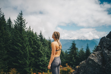 Naklejka premium Woman at a Vista in a Pacific Northwest Forest