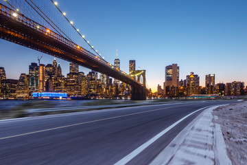 empty asphalt highway through modern city