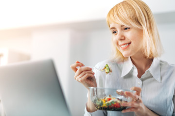 Woman Manager at the Office eating a salad