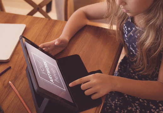 Child Using Tablet on Table Mockup