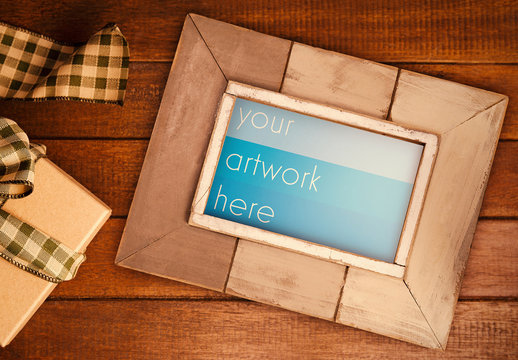 Frame Mockup by a Gift Box