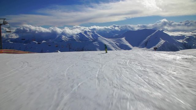 Downhill on a snowboard, in a ski, beautiful mountain view