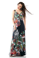 young beautiful woman in sundress with colorful flower pattern, long hair, full body portrait