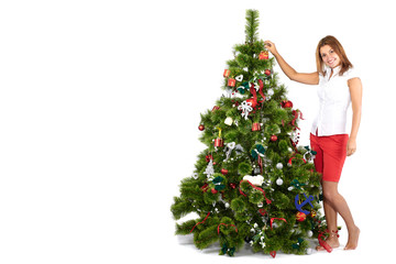 Beautiful smiling woman in red, decorating christmas tree, isolated on white