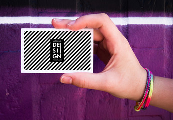 Hand holding Mockup business card over colorful background.