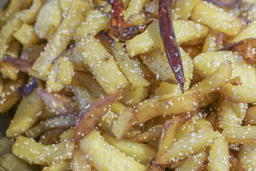 Fried potato pieces with fried red chilly