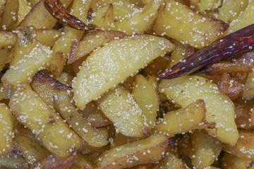 Fried potato pieces with fried red chilly