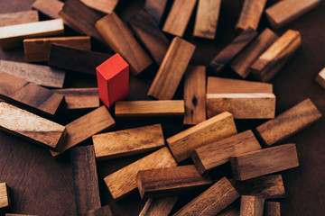 business leadership  ideas concept with red wood block stand out from other brown block