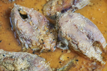 Hilsa fish pieces on a plate.