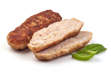 Fried long pork cutlets with basil leaves, isolated on white background.