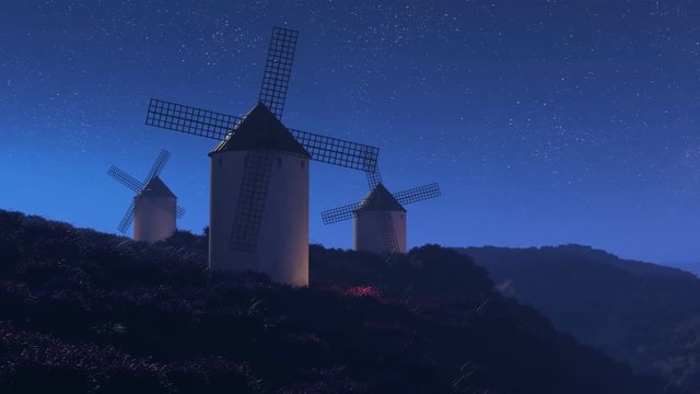 Multiple old, vintage, Spanish windmills rotating slowly at night. 4K HD
