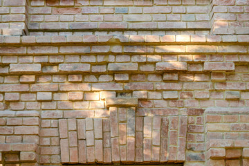 Old brick ancient wall background. Decorative abstract background. Rough red old brickwork. Used for conceptual and visual design texture.