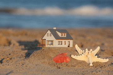 Close up of model house on the sandy beach. Blur Background