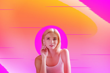 Beautiful photo. Cheerful pleasant woman sitting against pink background while smiling to you