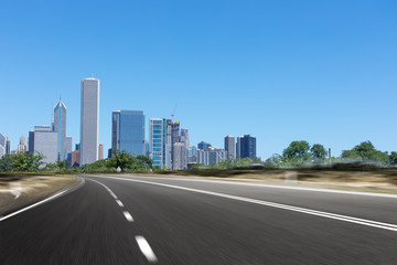 Fototapeta na wymiar asphalt highway with modern city in chicago