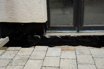 Waterproofing house foundation with spray on tar
