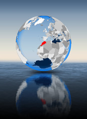 Morocco on globe in water