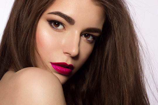 Beauty Face. Beautiful Woman With Sexy Full Pink Lips. Closeup Portrait Of Girl With Healthy Smooth Facial Skin Applying Lip Balm On Lip. High Resolution. cosmetology, make up, injections, spa