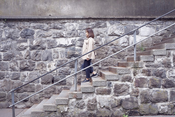 Working woman is walking  down the stairs.