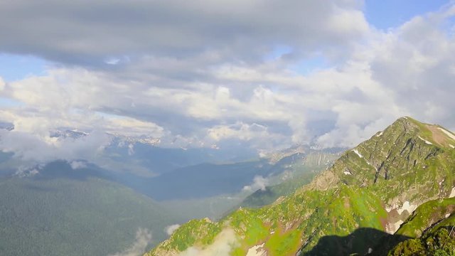 Flight of the camera over mountains. Aibga Ridge. Mountain Kamennyy stolb. 2509m. Mountains near the ski resort of Rosa Khutor in Krasnaya Polyana. Sochi, timelapse